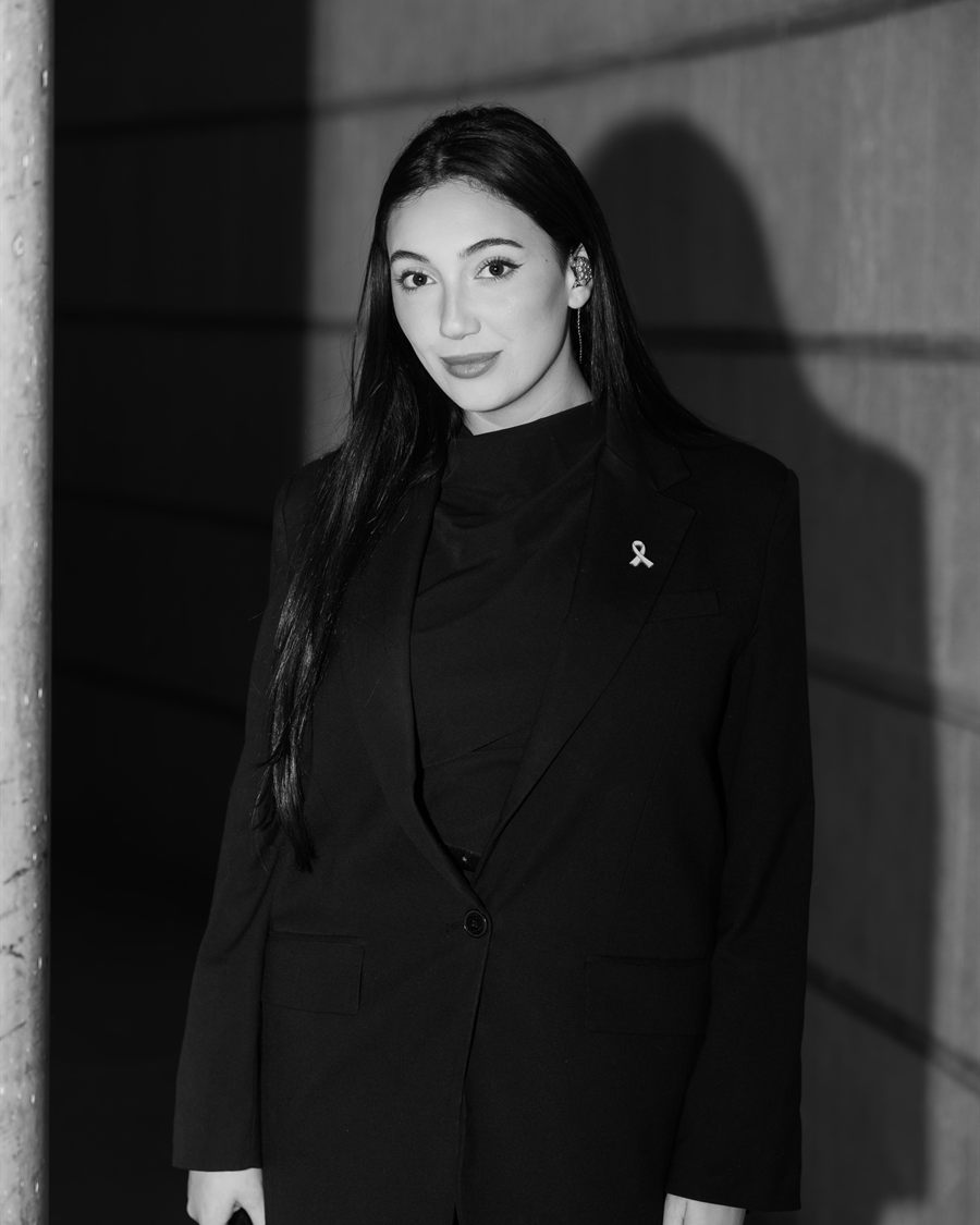 Black and white editorial portrait of a singer holding a microphone.