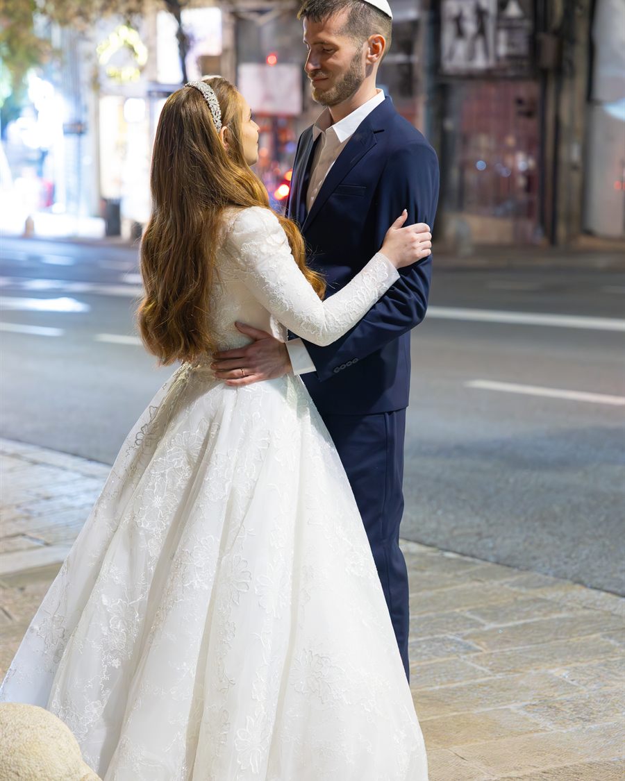 Wedding couple sharing a quiet portrait in the city.
